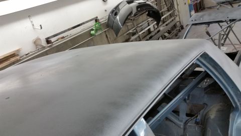 2001 Ford Crown Victoria - Photograph of a primed car roof panel during restoration, not a technical document.