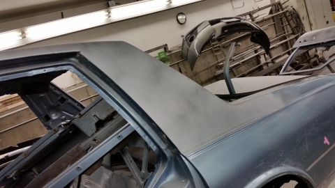 2001 Ford Crown Victoria - Photograph of a car roof and pillar during bodywork, not a technical document.
