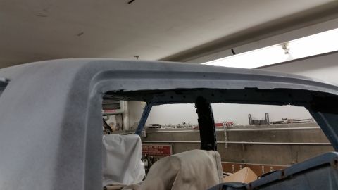 2001 Ford Crown Victoria - Photo of a primered roof and window opening on a project car, not a document.