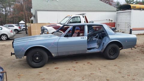2001 Ford Crown Victoria - Photo of a light blue sedan project car side profile, not a document.