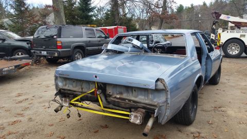 2001 Ford Crown Victoria - Photo of a project sedan rear with bumper off, not a document.
