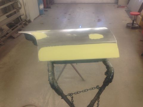 2001 Ford Crown Victoria - Photo of a fender panel with body filler on a stand, not a document.