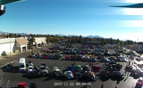 1979 Ford Bronco - An aerial view shows a large outdoor car show with dozens of classic cars parked in rows under a clear blue sky. The vehicles range in colo…
