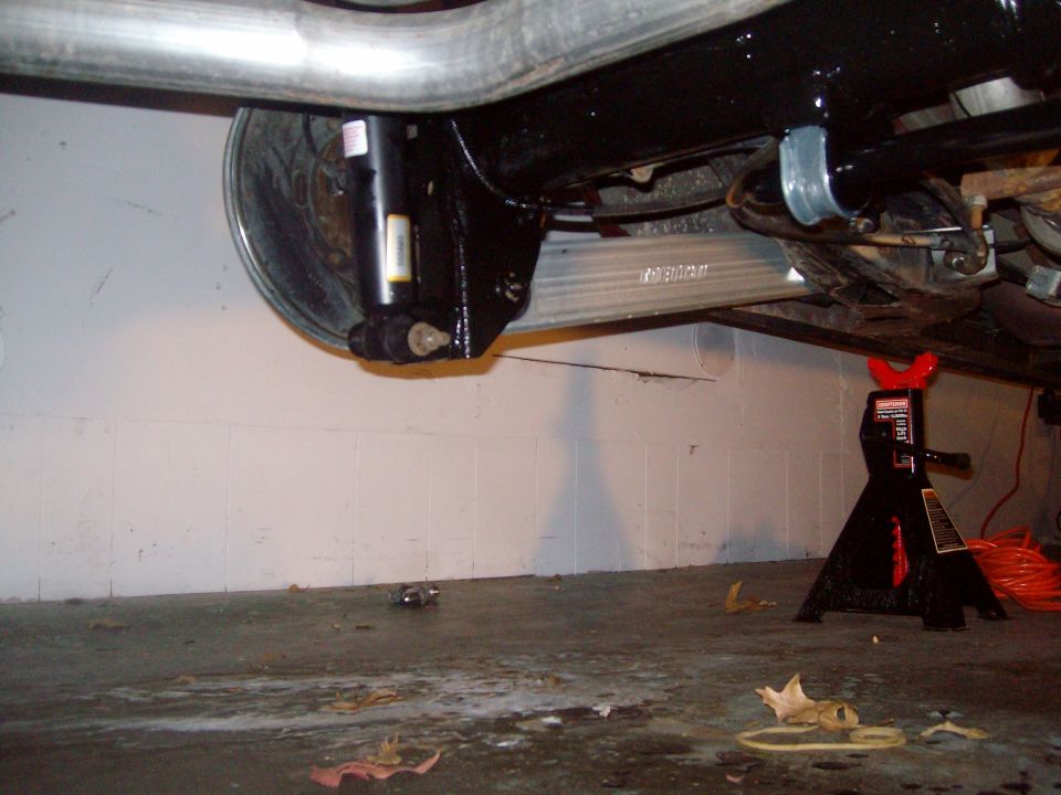 Rear suspension components and exhaust pipe of a vehicle, supported by jack stands