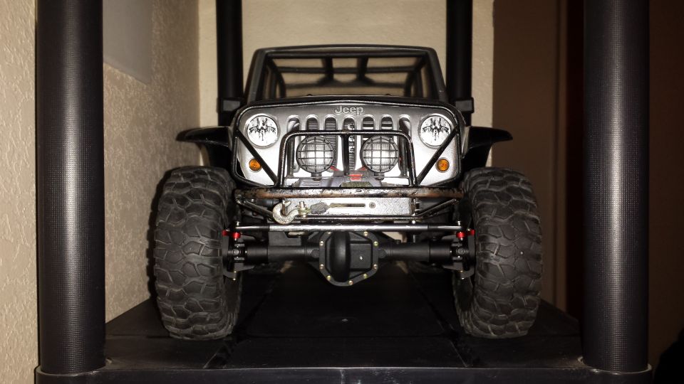 Front view of a remote-control Jeep Wrangler with off-road tires and winch.