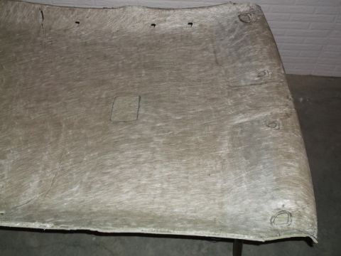 1999 Mercury Grand Marquis - The underside of a car's headliner is shown, featuring a square cutout and several circular mounting points. The material appears to be a t…