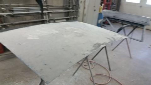 2001 Ford Crown Victoria - Photo of a primered roof panel on stands, not a technical document.