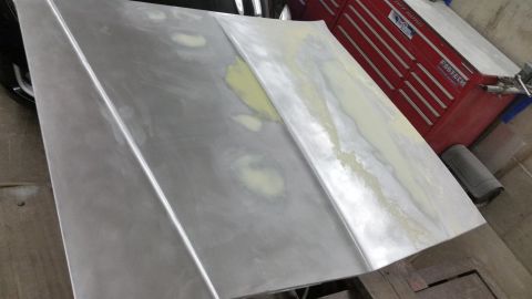 2001 Ford Crown Victoria - Photo of sheet-metal panels with filler during bodywork, not a document.