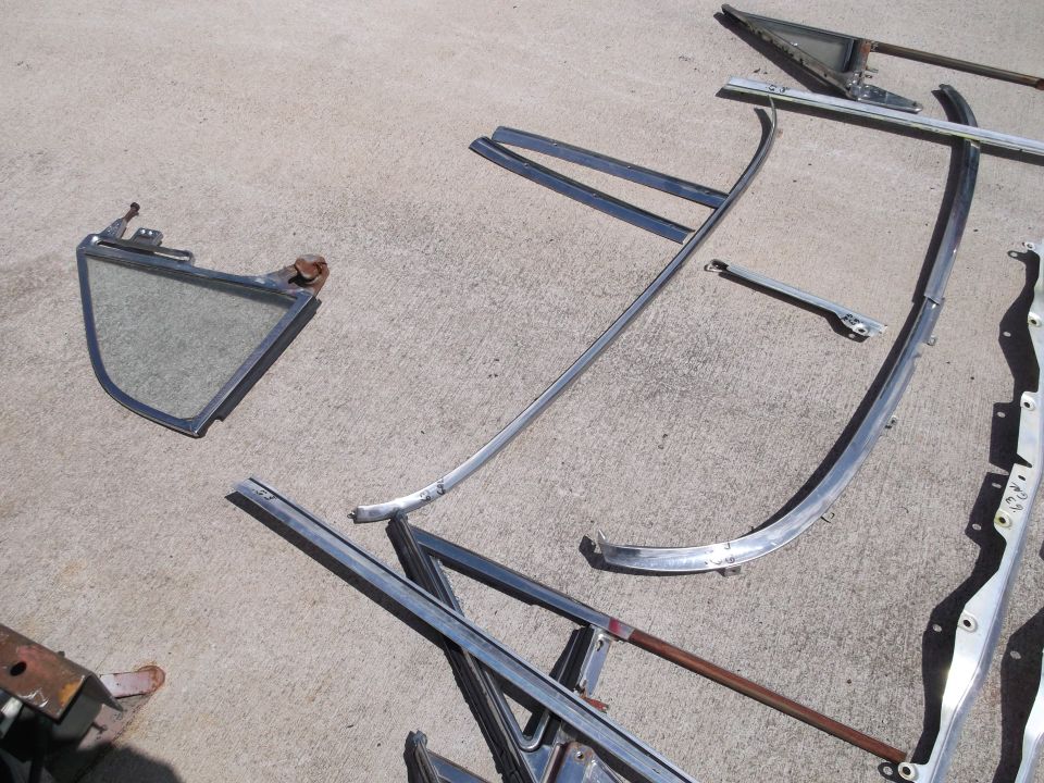 Chrome trim pieces and a vent window on concrete