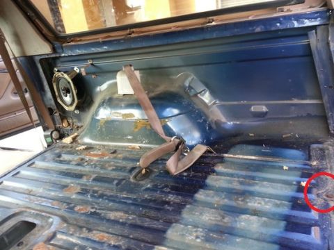 1994 Ford Bronco - Photograph of a truck rear interior and floor, not a technical document.