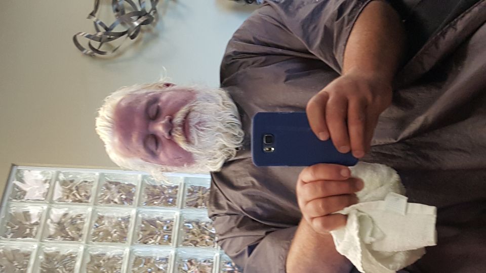 Person with white hair and beard, and purple tinted skin, taking a selfie.