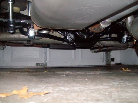 2004 Ford Crown Victoria - The underside of a vehicle, likely a Ford Crown Victoria, is shown from a low angle, focusing on the rear differential, exhaust system, and…