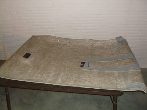 1999 Mercury Grand Marquis - This is a view of the underside of a car's headliner, likely from a 1999 Mercury Grand Marquis. It is laid out on a table and shows a squar…