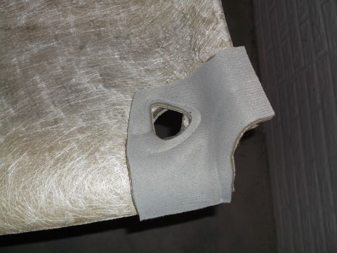 1999 Mercury Grand Marquis - A close-up shot shows a piece of light gray fabric with a triangular cutout, attached to a textured, fibrous material. The fabric appears t…