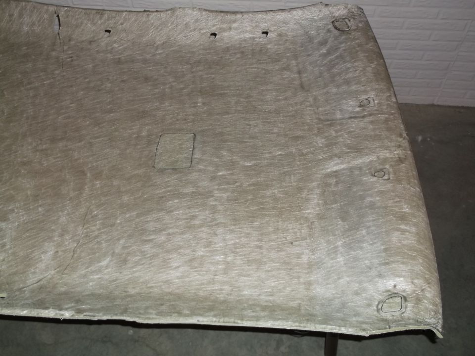 Underside of a car headliner with cutouts