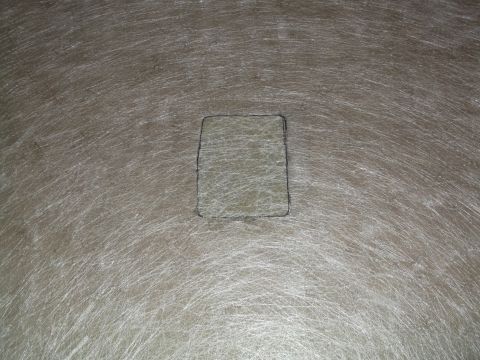 1999 Mercury Grand Marquis - A close-up view of a rectangular patch drawn with a dark marker on a textured, fibrous surface. The surface has many fine, white, parallel…