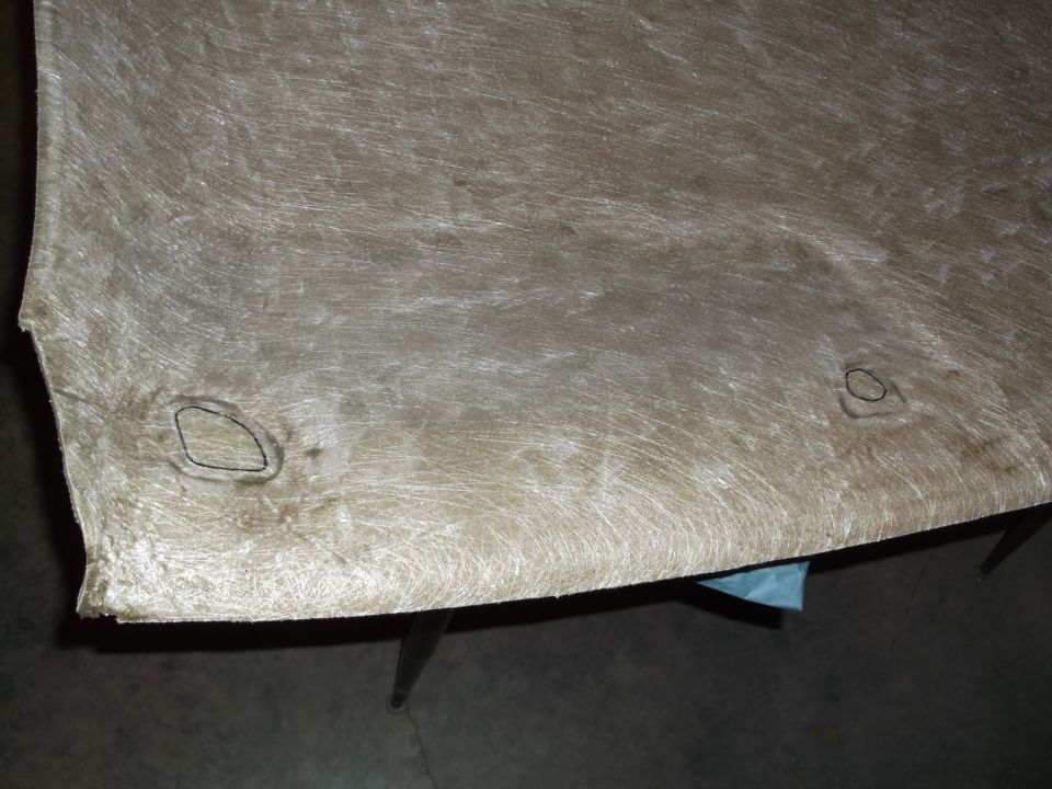 Underside of vehicle headliner with two circular cutouts.