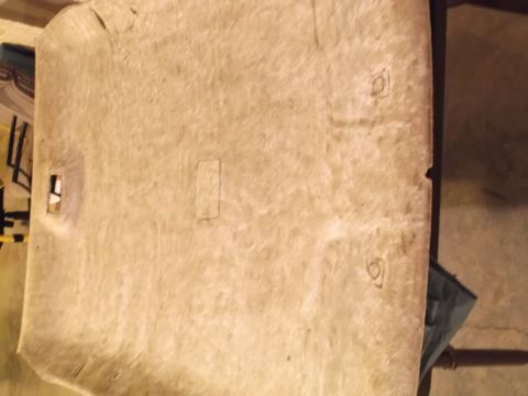 1999 Mercury Grand Marquis - The underside of a tan headliner with cutouts for lights and mounting points. The headliner appears to be from a 1999 Mercury Grand Marquis.
