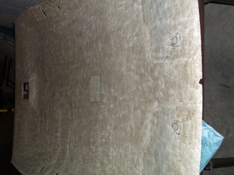 1999 Mercury Grand Marquis - The underside of a vehicle's headliner is shown, likely removed for modification or repair. It is a light beige color with some visible mar…