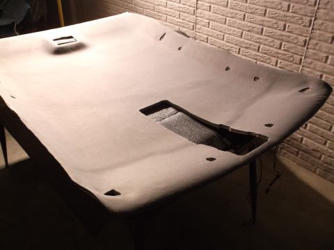 1999 Mercury Grand Marquis - A disassembled car headliner is laid out on a table, showing cutouts for lights and other fixtures. The headliner appears to be a light gra…