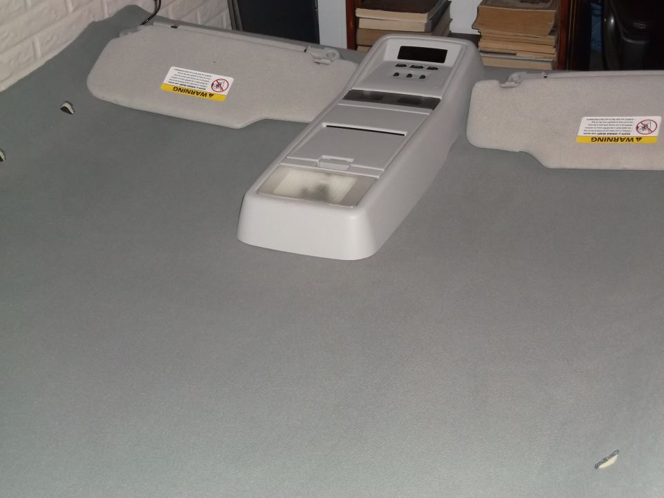 Overhead console and sun visors on gray fabric surface