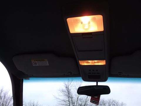 1999 Mercury Grand Marquis - Interior view of a vehicle's overhead console and sun visor, with illuminated lights.