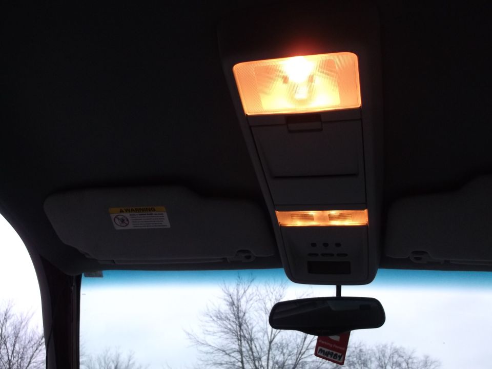 Overhead console lights and sun visor in a vehicle interior