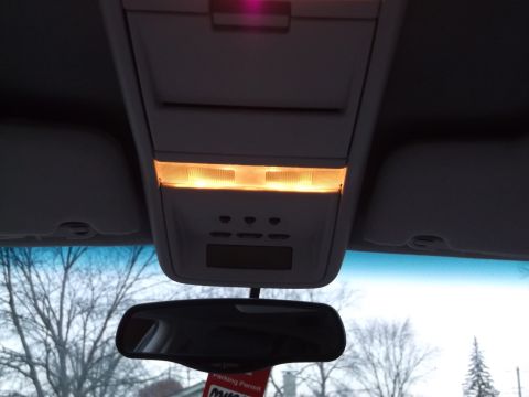 1999 Mercury Grand Marquis - Interior view of a vehicle's overhead console, illuminated lights and a rearview mirror.