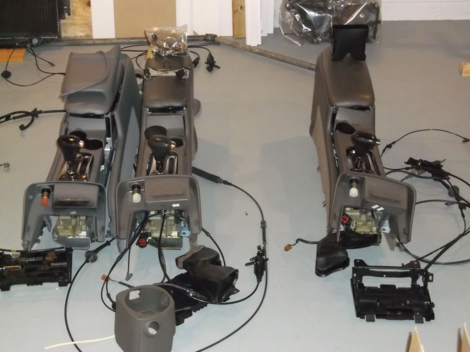 Three car consoles with shifters and wiring