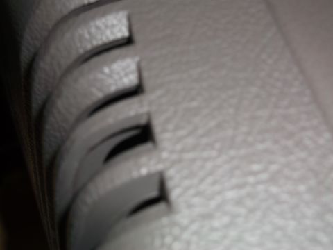 1999 Mercury Grand Marquis - Close-up of a car's interior console shows textured plastic with curved openings.