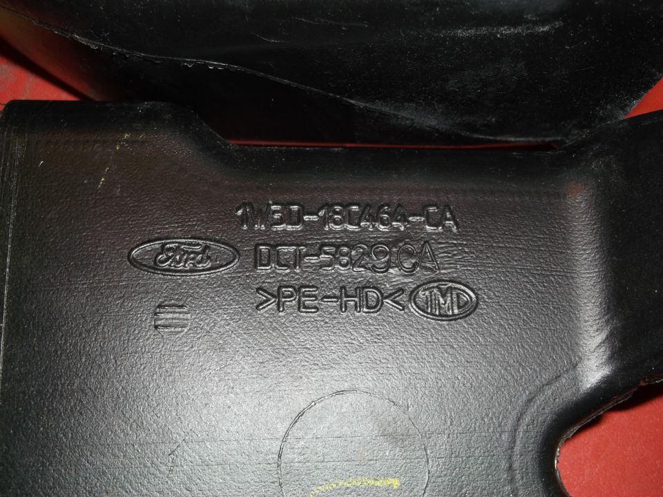 Black plastic Ford part with embossed part numbers 1M3D-13C464-CA and DCI-5829CA