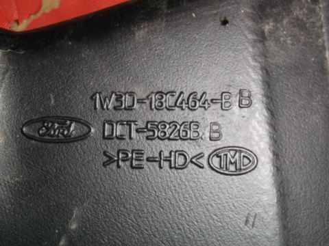 1999 Mercury Grand Marquis - A black plastic automotive part displays embossed Ford branding and part identification numbers.