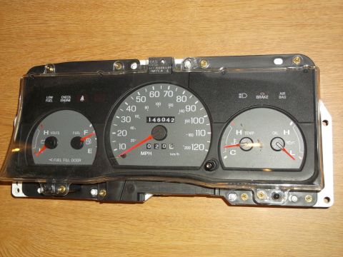 1999 Mercury Grand Marquis - Car dashboard instrument cluster showing speedometer, fuel, temp, and oil gauges with 146042 miles.
