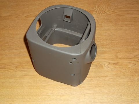 1999 Mercury Grand Marquis - A gray plastic steering column cover is shown from a 3/4 front angle, resting on a wooden surface.