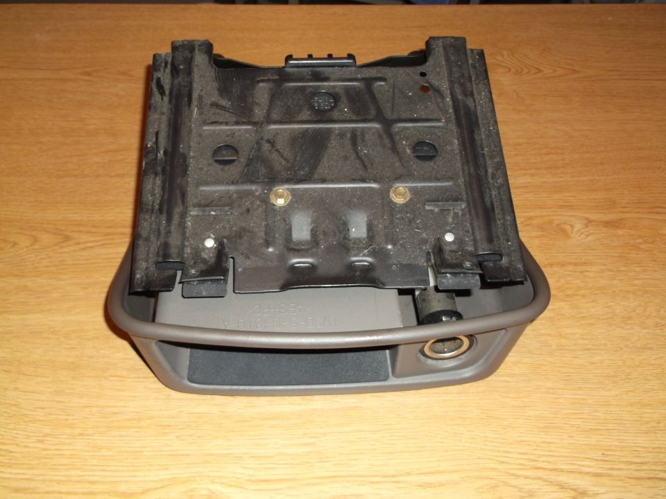 Car center console ash tray and cigarette lighter assembly, close-up overhead view.