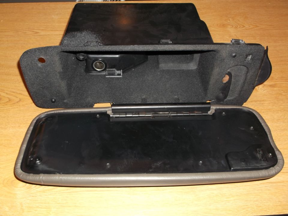 Open glove box compartment with 12V power outlet.