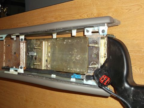 1999 Mercury Grand Marquis - This is a close-up view of the disassembled interior of a 1999 Mercury Grand Marquis center console, showing the internal metal structure a…