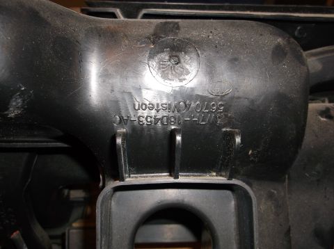 1999 Mercury Grand Marquis - A close-up view shows black plastic part with embossed text that reads "3M7H-18D453-AC 5670 ACVisteon". A circular emblem with a screw is v…