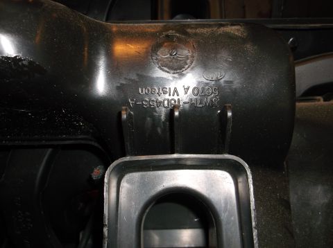 1999 Mercury Grand Marquis - A black plastic part with embossed text is shown. The text reads "3W7H-18D453-A 5670 A VISTEON" and includes a circular logo that appears t…