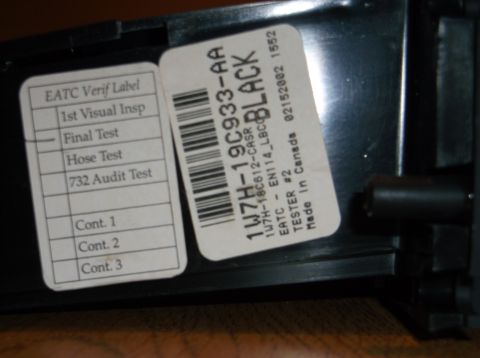 1999 Mercury Grand Marquis - A close-up view of two labels attached to a black plastic component. The label on the left has a checklist with items like '1st Visual Insp…