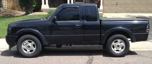 Black Ford Ranger pickup truck, side view