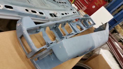 2001 Ford Crown Victoria - Photograph of primered automotive body parts in a workshop, not a technical document.
