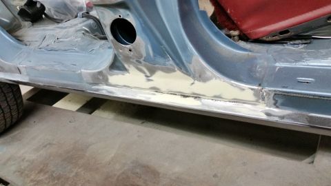 2001 Ford Crown Victoria - Photograph of a repaired rocker panel on a car body, not a technical document.