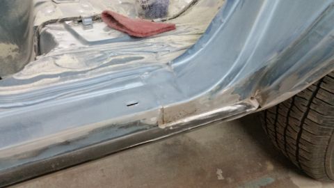 2001 Ford Crown Victoria - Photograph of a repaired lower rocker panel on a car, not a technical document.