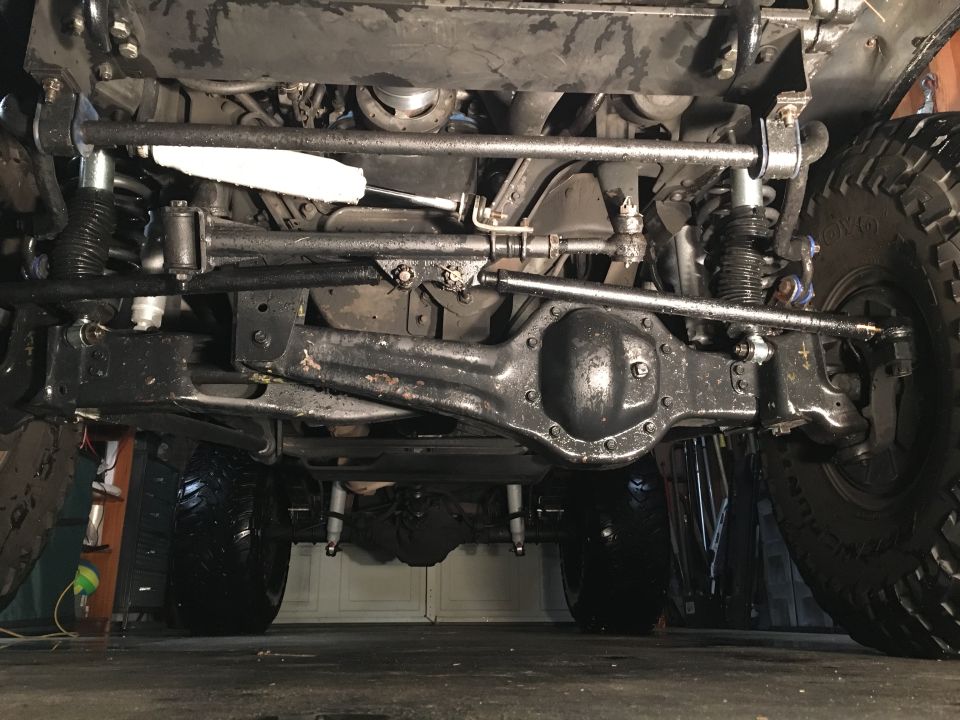 Underside view of a 1993 Ford Bronco, showing front axle, steering, and suspension.