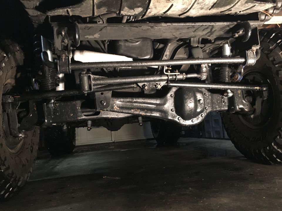 Underside of a 1993 Ford Bronco showing front axle, steering, and suspension.