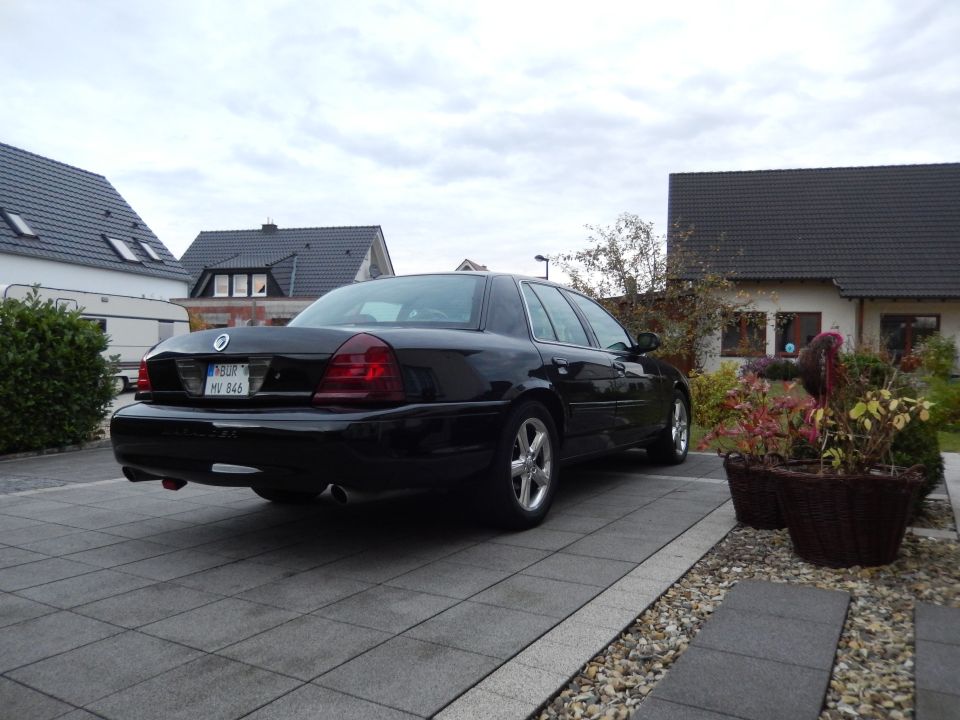 Black Mercury Marauder parked on a paved driveway, rear 3/4 view.