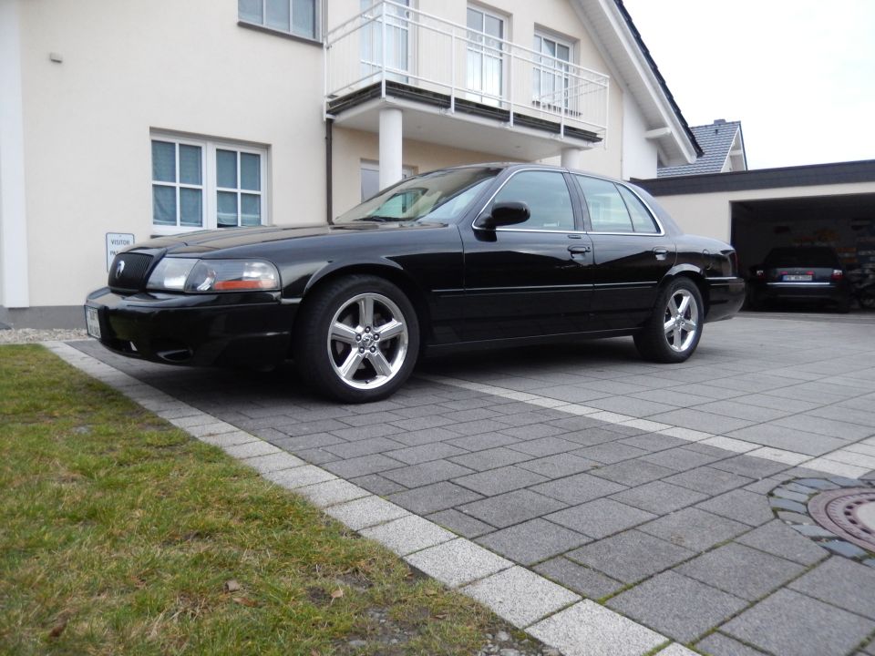 Black 2003 Mercury Marauder parked in front of a house.