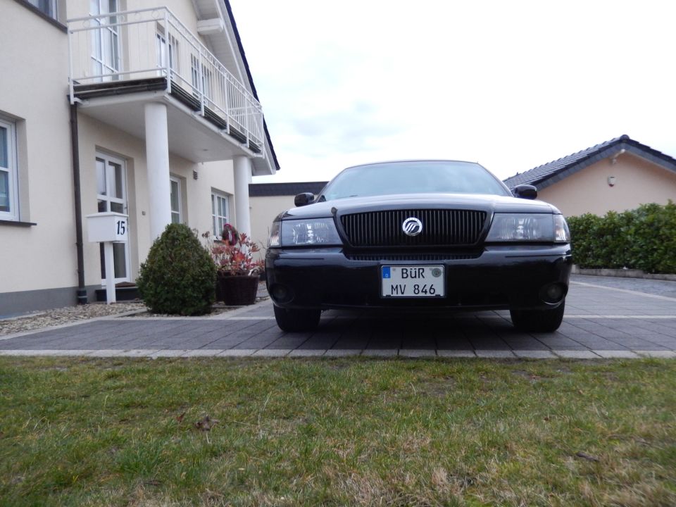 Black 2003 Mercury Marauder parked in front of a house, front view.