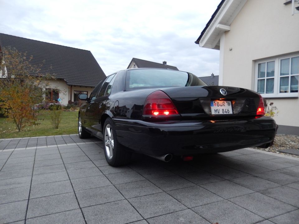 Black 2003 Mercury Marauder rear driver's side view with illuminated taillights.